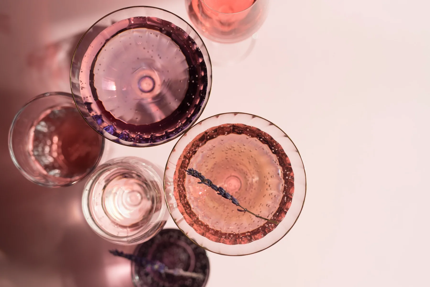 An overhead arrangement of coupe glasses and reflections