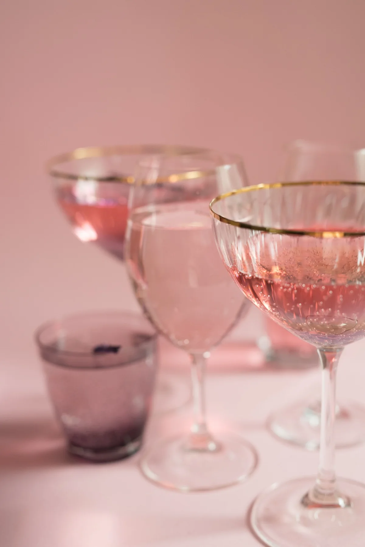 Champagne coupes and pink glassware catching the light