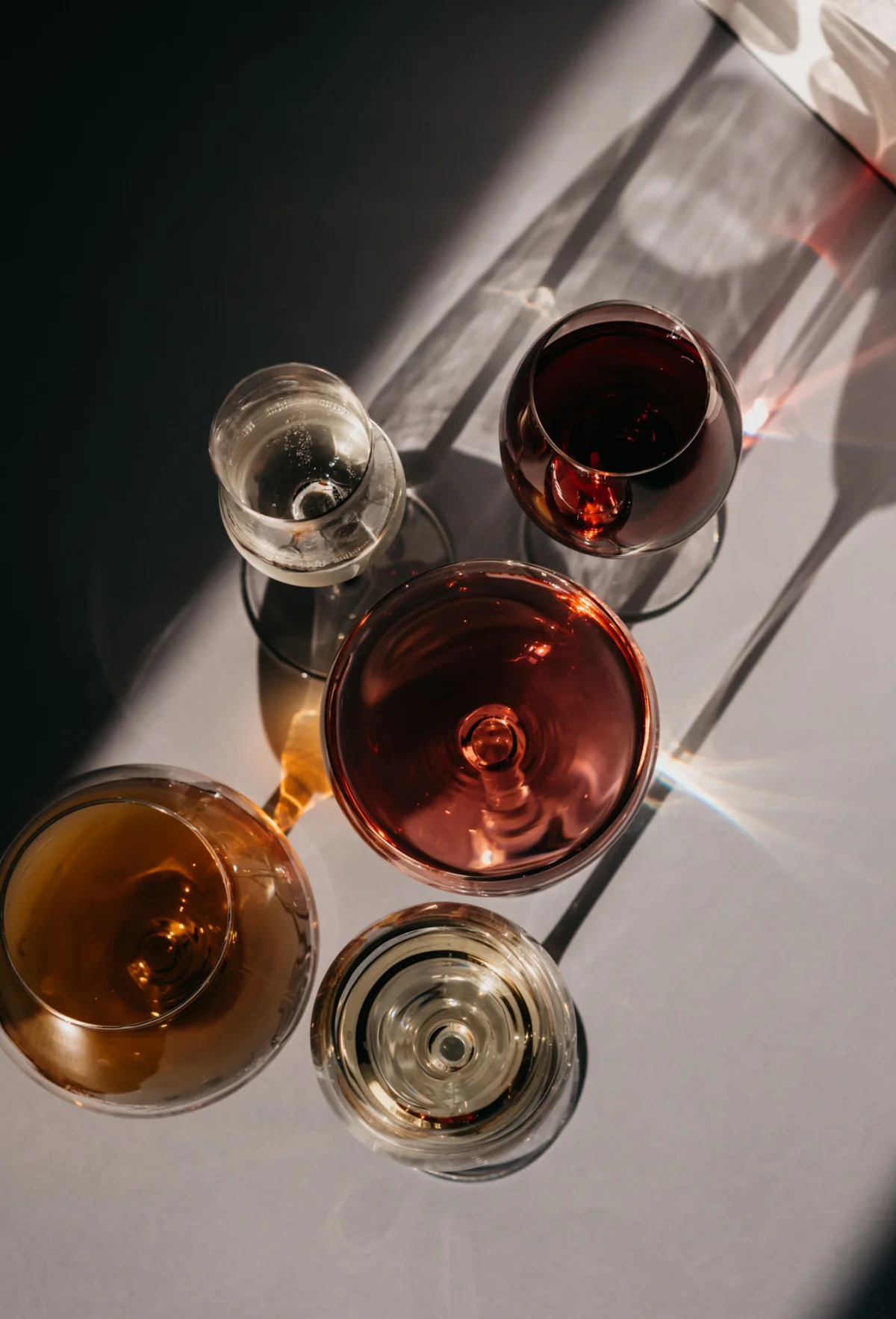 An arrangement of glasses and long afternoon shadows